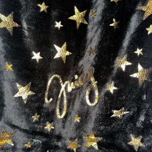 Juicy Couture black and gold star blanket.